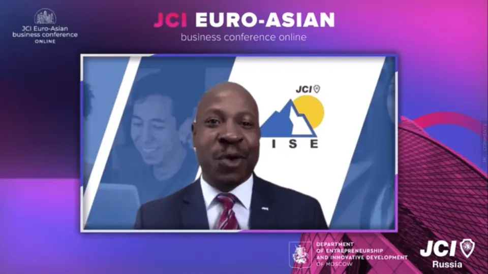 A speaker in a suit on screen during the online JCI Euro-Asian business conference
