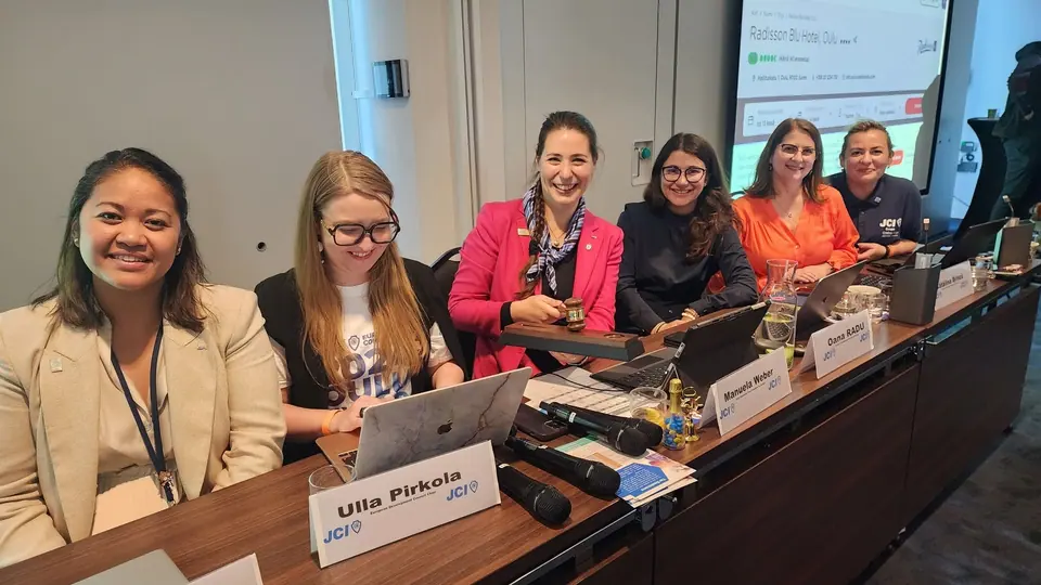 The European Conference assembly team seated at a table with laptops and name cards
