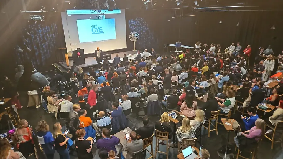 A packed conference hall seen from above during the Creative Young Entrepreneur competition