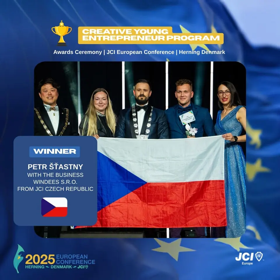 Winners card for the Creative Young Entrepreneur Program: Petr Šťastny, Windees s.r.o., JCI Czech Republic, on stage with the Czech flag