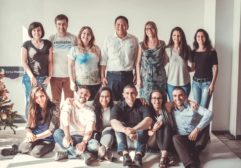 A group of JCI Bulgaria members sitting and standing together after a strategic planning session