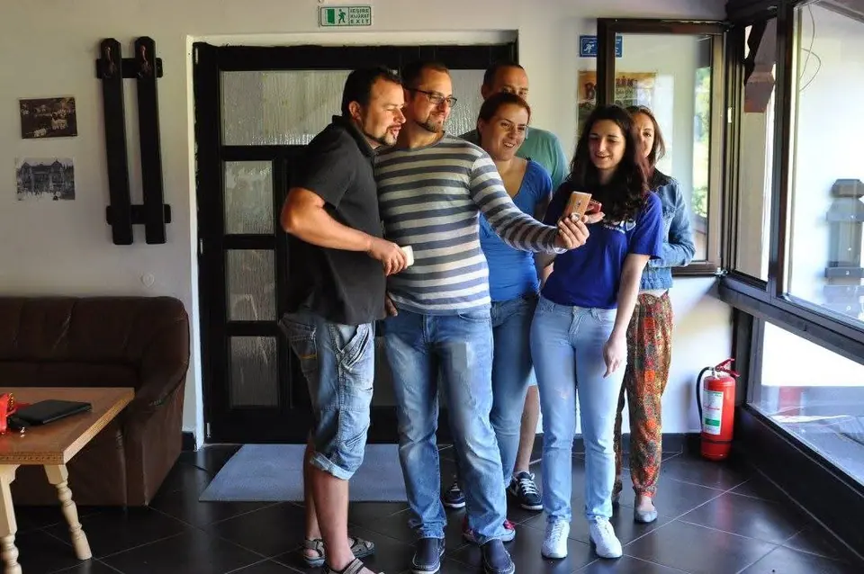 A group of volunteers taking a selfie in a hallway