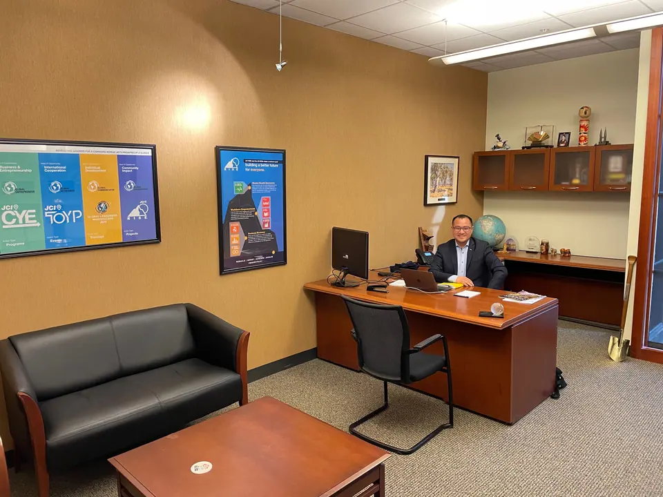 The Secretary General's office at JCI headquarters, with a desk, sofa and JCI posters