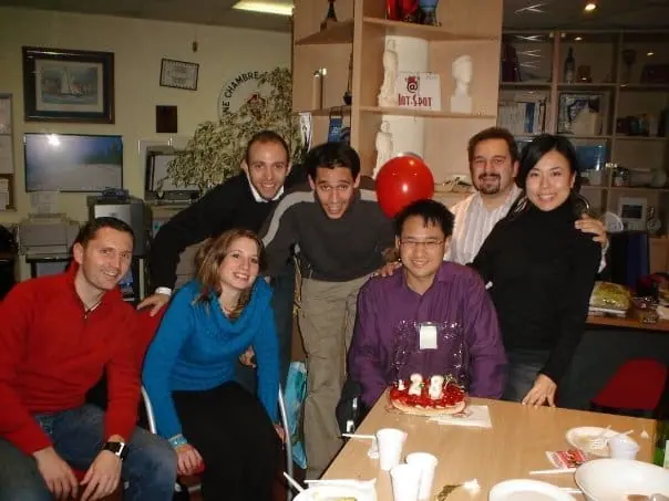Ten members smiling around a table at a committee meeting