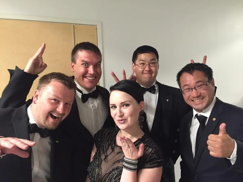 Five Vice Presidents in dinner jackets and evening dress posing and laughing