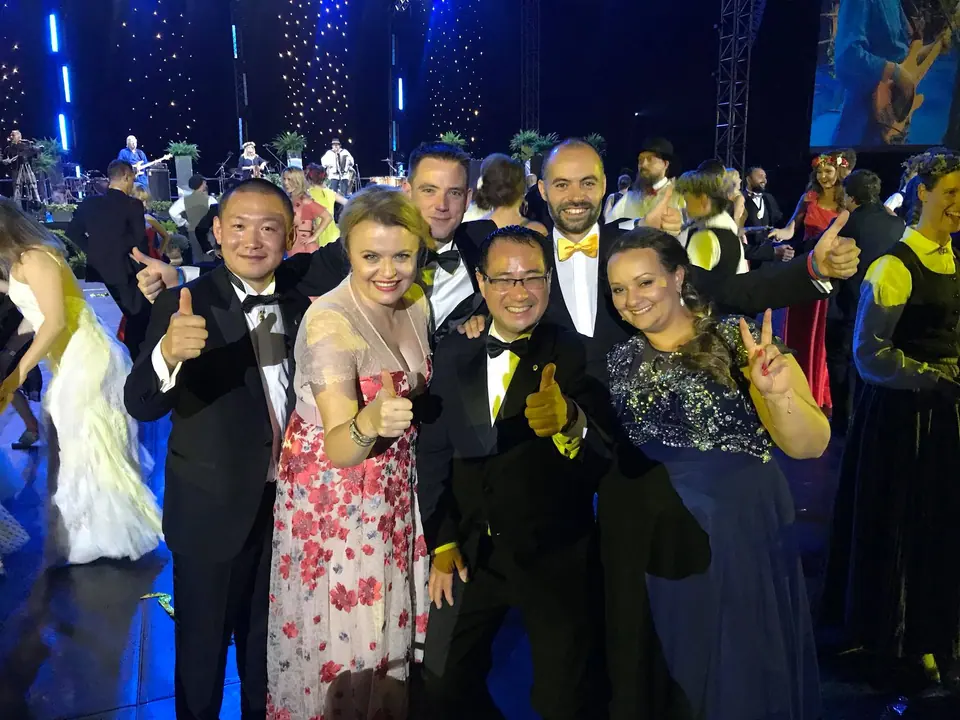 Vice Presidents in evening wear giving thumbs up at the European Conference gala in Riga