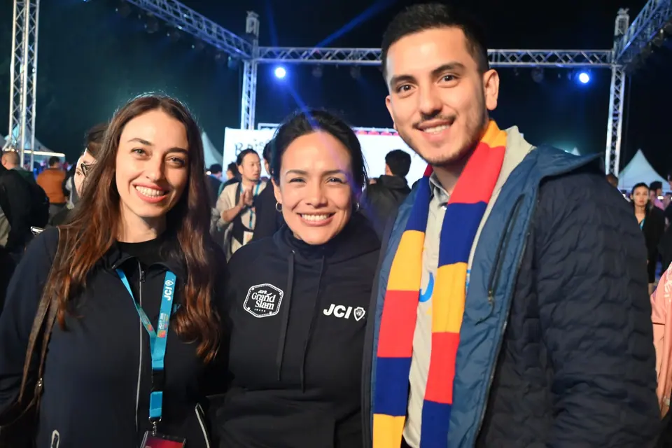 Nihal Zoroğlu with two other JCI members at an evening event, one wearing a colourful scarf
