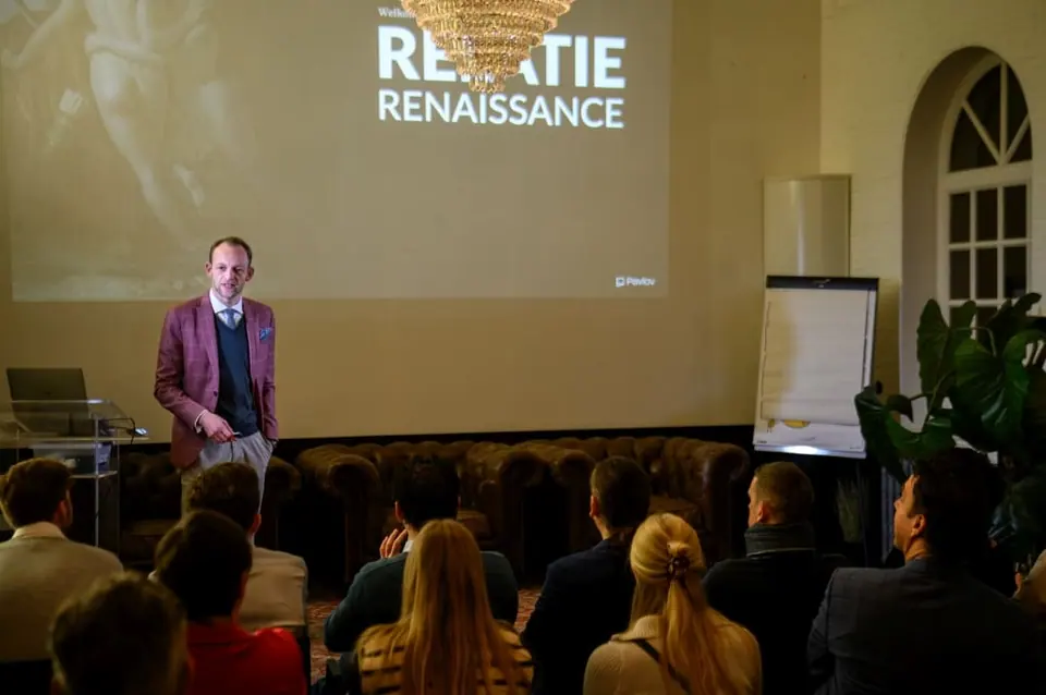 Stef Verbeeck presenting in front of a Relatie Renaissance slide to a seated audience