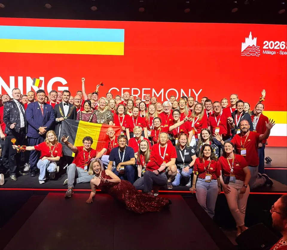 A large group in red T-shirts on stage at the opening ceremony of the 2026 European Conference in Málaga